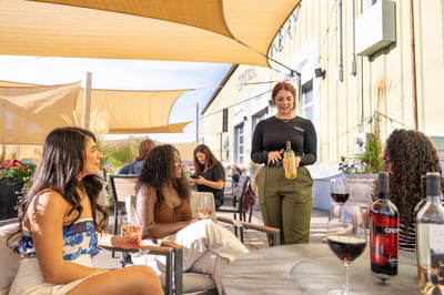 Idaho tasting room staff teaching group of girls on patio about Idaho wine