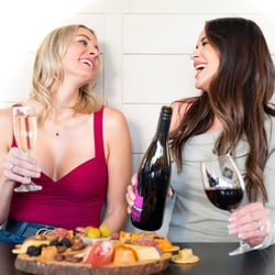 Women drinking Idaho wine with charcuterie board