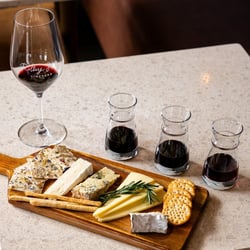 3 wine tasting glasses and a cheese board from an Idaho winery