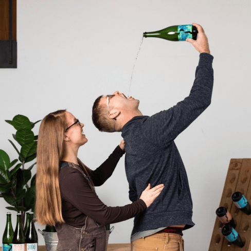 Bottle of Sparkling Gewürztraminer being poured into man’s mouth