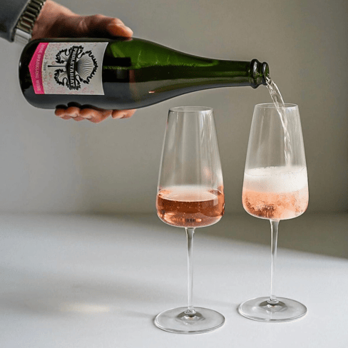 Bottle of Proletariat Wine Company’s Sparkling Rosé being poured into glasses