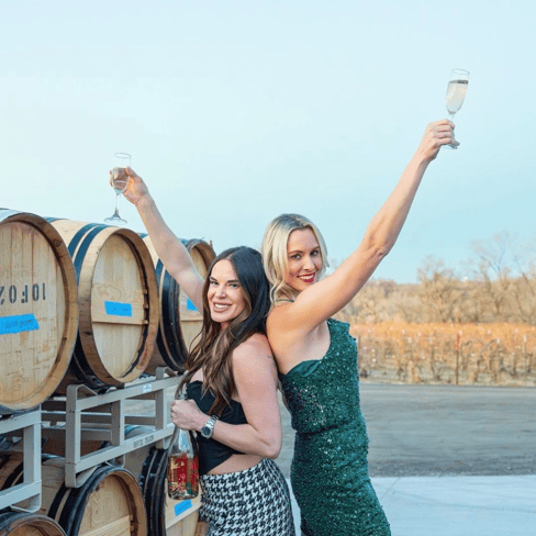 Caitlin Holesinsky and Natalie Vander’pol from Holesinsky winery holding glasses of sparkling wine