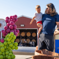 man and son stomping grapes