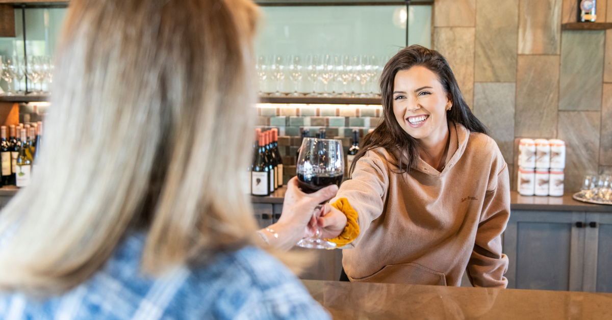 woman pouring wine during winery event